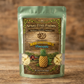 Harvested freeze-dried pineapple in a light green mylar bag